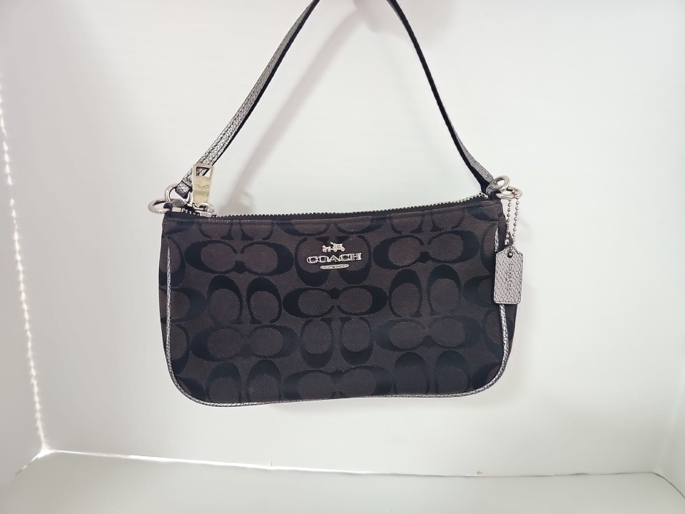 Coach wristlet Clutch in signature black canvas In Silver Trim 9″×5″